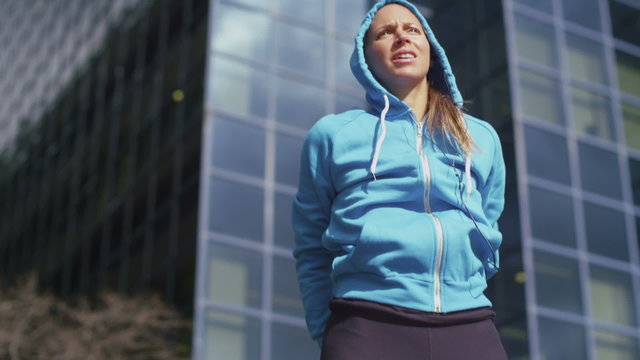 Athletic woman stretching before in the city in slow motion