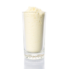 Full cream milk powder in a glass over white background