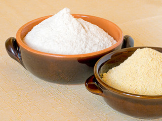 Wheat and maize flour in bowls. Unbleached, stone ground.