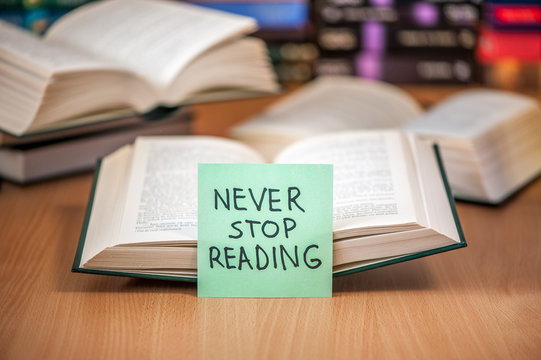 open book with post it never stop reading message