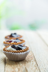 Three Blue berry tart on wooden floor