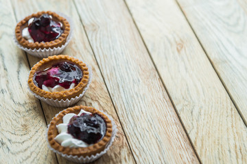 Three Blue berry tart on wooden floor