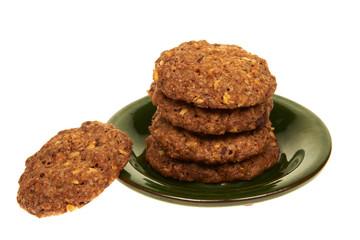 Cookies with nuts isolated on a green plate on white background