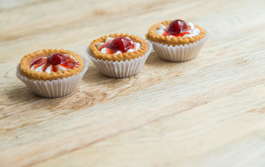Three Strawberry tart on wooden floor