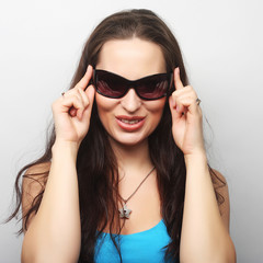 Fototapeta premium Young surprised woman wearing sunglasses.