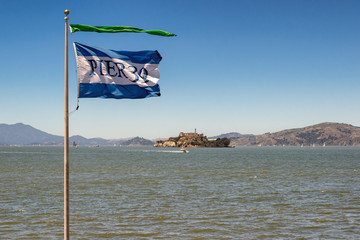 Flag pier 39 and Alcatraz Island in San Francisco, USA.
