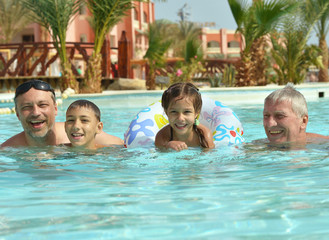 family relax in the poo