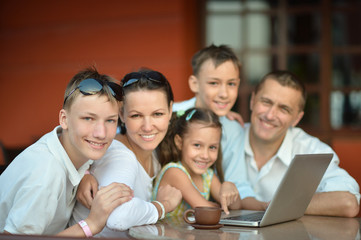 family sitting with laptop