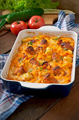 Casserole with sausage, bacon and apples in a pumpkin sauce