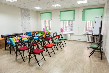 Room for meeting arranged chairs and flipchart, office space