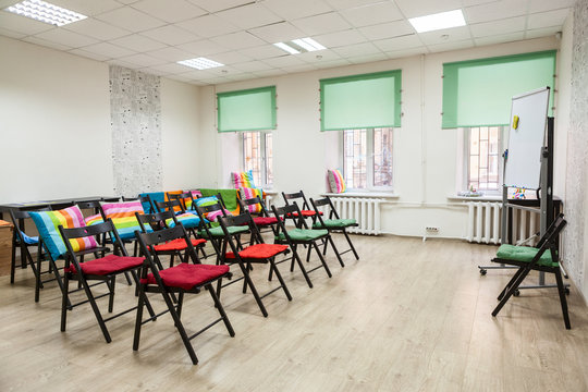 Chairs with colored capes in the hall for seminar or meeting