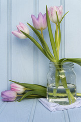 Beautiful Spring flower still life with wooden background and ho