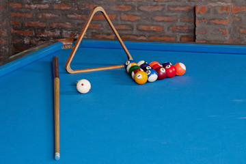 Billiards. billiard balls and cues on blue table