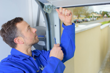 Man installing a garage door