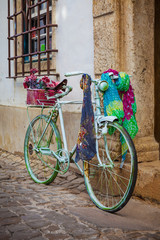 Fototapeta na wymiar Vintage bicycle leaning against an old door in a medieval street