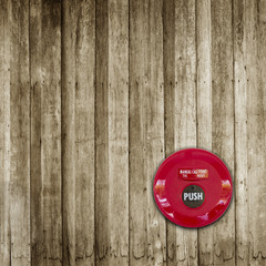 Fire break glass alarm switch on wooden wall background