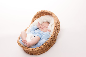 New born baby sleeps in basket