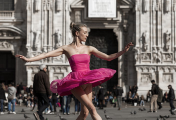 Fototapeta na wymiar Beautiful dancer wearing pink dress performing in Milan