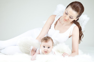 Obraz na płótnie Canvas Beautiful woman with a baby angel