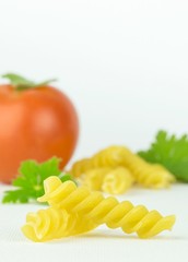 Spiral pasta pieces with tomato herbs and copy space