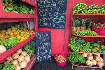 Pineapples and other fruits for sale at a roadside stand on Maui
