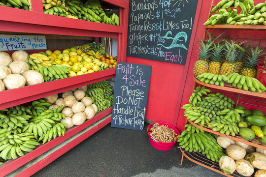 Pineapples and other fruits for sale at a roadside stand on Maui