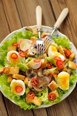 Salad Caesar with mushrooms, eggs, chili and radish with two for