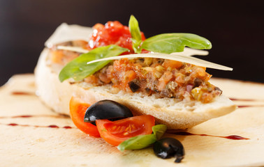 Italian appetizer bruschetta with tomato, basil and black olives