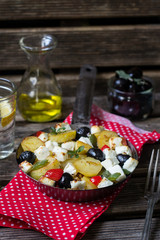 Greek potatoes skillet with feta cheese, olives and pepper