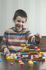 Fototapeta premium Child play with children's constructor toys