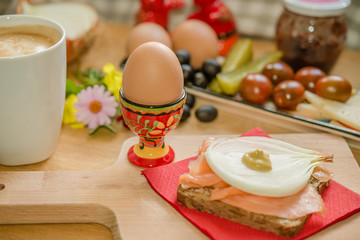 Bistro breakfast sandwich boiled eggs coffee on wooden tablet