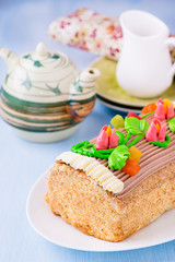 Roulade cake, decorated with colourful buttercream flowers