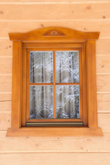 Window with thread in a wooden house