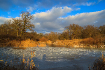 Frozen river in the winter at sunset