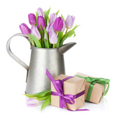 Purple tulip bouquet in watering can and gift boxes