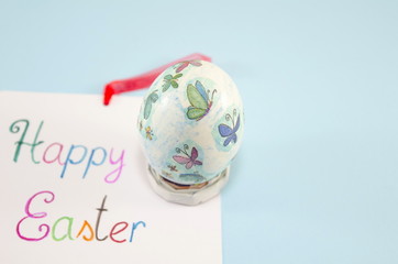 Hand painted Easter egg on blue background