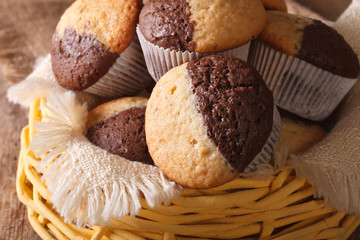 two-tone muffins orange and chocolate closeup in basket
