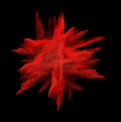 Freeze motion of red dust explosion isolated on black background
