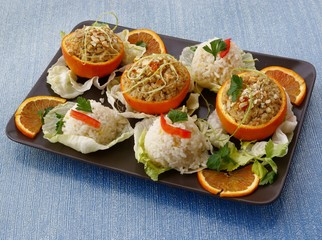 pork meat stuffed in oranges and rice as tasty meal