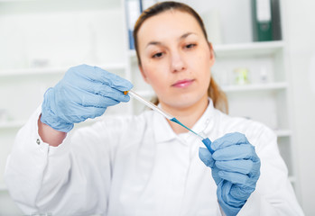 female researcher with glass equipment in the lab 