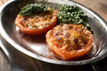 Baked tomato halves covered in cheese and spices