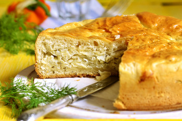 Traditional russian yeast pie with cabbage and dill.