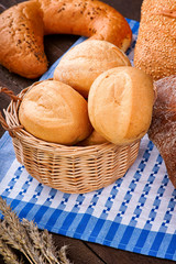 Wicker basket with buns on the tablecloth