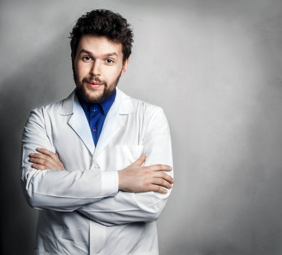 Confused doctor man posing with folded arms