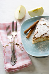 A piece of apple pie lying on blue plate, apple, cinnamon sticks