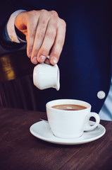 cream into coffee