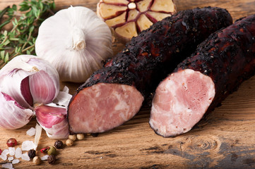 Dried sausage with garlic bulbs and fresh rosemary