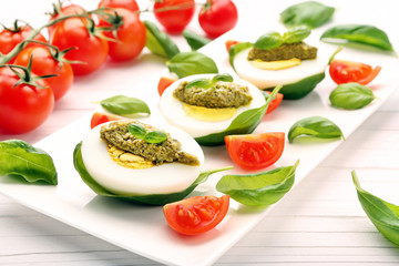 Easter eggs with pesto and cherry tomatoes