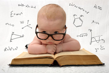 little baby in glasses with eauations around