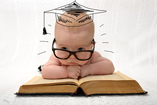 cute little baby in glasses with painted professor hat